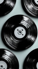 Black vinyl records on light teal background
