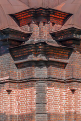 Fragment of the facade of a brick historical building on an autumn day
