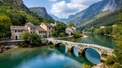 Fototapeta premium Beautiful landscape with an old stone bridge featuring traditional houses and mountains