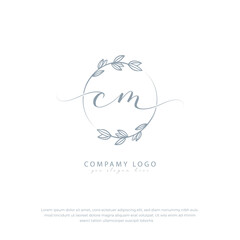 Handwritten cm initial logo with botanical