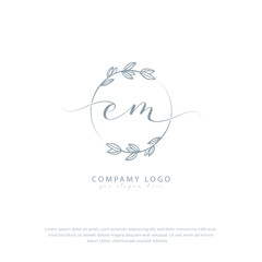 Handwritten em initial logo with botanical