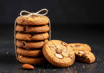 Stack of Chocolate Chip Cookies with Almonds on Dark Background. National Homemade Cookies Day