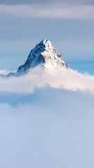 Snowy mountain peak above a sea of clouds