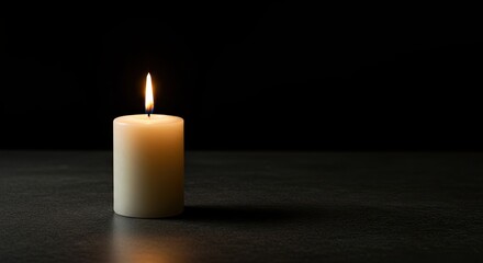 Burning Cream Candle Glowing on Dark Surface in Studio Setting