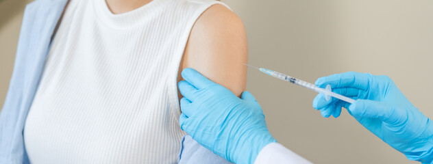 Health care, corona virus, hand of woman nurse, doctor giving syringe vaccine, injection dose on arm sick patient at clinic. Vaccination, immunization disease prevention against flu pandemic influenza