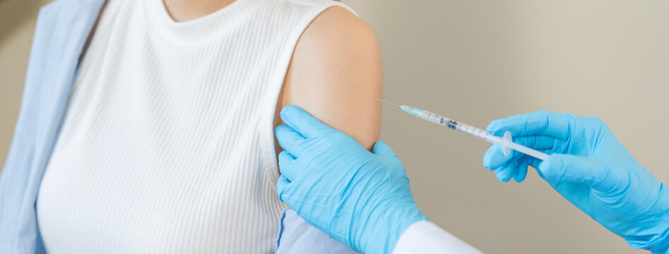 Health care, corona virus, hand of woman nurse, doctor giving syringe vaccine, injection dose on arm sick patient at clinic. Vaccination, immunization disease prevention against flu pandemic influenza