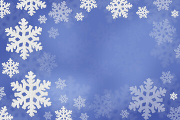 Christmas blue background of white snowflakes flying in the air. Holiday card for New Year and Christmas with space for greetings, labels and your design.