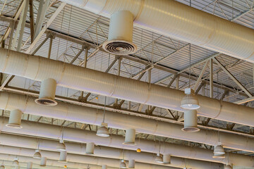 Air conditioning ducts on the ceiling of a large building hall