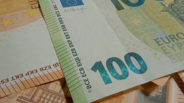 Explore the fine details of a Euro banknote with a macro perspective that captures its unique features and vibrant colors, highlighting the artistry of currency design.