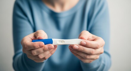 Woman Holding Pregnancy Test Positive Result.