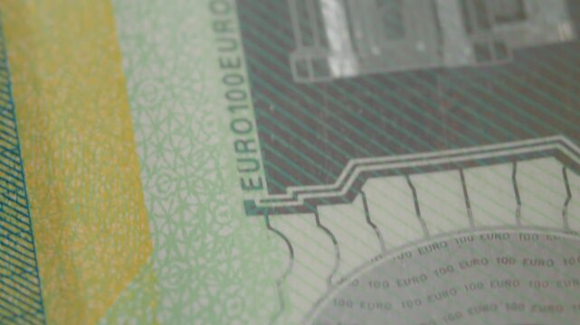 Explore the fascinating details of euro banknotes as the macro perspective captures textures, colors, and security features that define this currency's unique design.