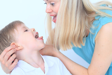 Mom's hands and child close-up, boy 4-6 years old, nose game