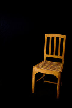 Old style wooden chair isolated on black background