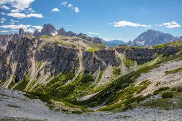 Rocky Peaks and Light Clouds and Green Grass