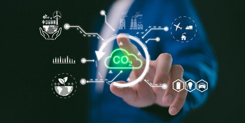 Businessman reducing carbon emissions with a glowing CO2 cloud and surrounding ecological icons. Concept of climate action, green technology, and a sustainable future.