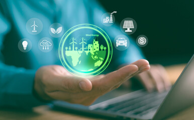 A hand holds a glowing holographic globe showing renewable energy, city, and trees, eco-friendly tech icons. sustainable development, green investment, and a greener future with digital innovation.