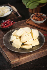 Fresh Yellow Bamboo Shoots with Asian Spices on Rustic Wooden Board for Traditional Cooking