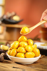 Roasted Chestnuts in Bowl with Wooden Spoon - Traditional Autumn Snack Food Preparation