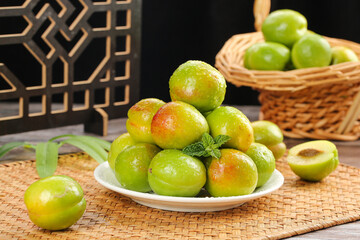 Fresh Green Apricots from Xinjiang - Freshly Picked Fruit Display on Bamboo Mat with Wicker Basket