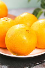 Fresh Navel Oranges with Water Droplets on White Plate - Healthy Citrus Fruit
