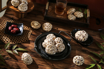 Dried Shiitake Mushrooms on Wooden Table with Traditional Asian Serving Dishes and Red Dates