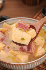 Bamboo Shoot Soup with Bacon - Traditional Asian Cuisine with Moso Bamboo and Herbs in Ceramic Bowl