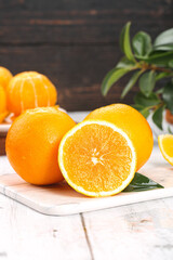 Fresh Orange Citrus Fruits on Wooden Board with Green Leaves - Healthy Food Photography