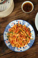 Asian Stir-Fried Rice Noodles with Vegetables on Traditional Porcelain Plate