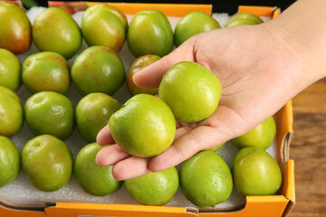 Fresh Xinjiang Green Pears in Hand - Large Ripe Fruits at Market Display