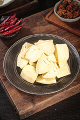 Fresh Bamboo Shoots with Asian Spices and Chili Peppers on Wooden Board