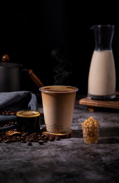 Coconut latte and pearl milk tea mix, black background