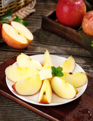 Premium Fresh Red Fuji Apple Slices from Sichuan Yanyuan Province with Mint Garnish on Rustic Wood Background