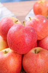 Fresh Red Fuji Apples with Water Droplets in Natural Light