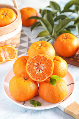 Fresh Mandarin Oranges with Green Leaves on White Plate - Healthy Citrus Fruit Still Life