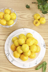 Xinjiang Yellow Apricots on White Marble Plate - Fresh Fruit Display on Wooden Background