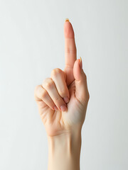 delicate female hand rests pure white background index finger extended pointing sharply upwards lit soft diffused