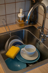 Dirty dishes - shallow focus. A mountain of unwashed dishes in the kitchen sink.