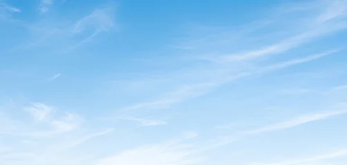 Light blue sky adorned with wispy white clouds drifting gently on a sunny day, creating an airy and natural background that feels refreshing and open. © al-sultan