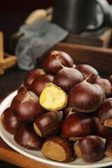 Fresh Roasted Yunnan Chestnuts with Open Shells Showing Golden Yellow Flesh on Plate