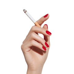 Hand holding a cigarette with red nails