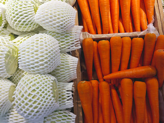 Fresh Vegetables Displayed in Market with Carrots and Cabbages