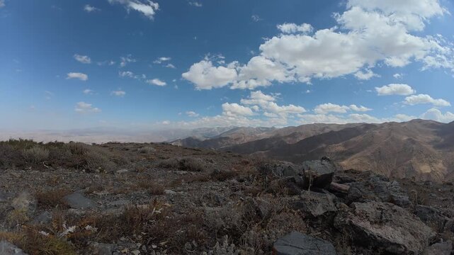 Timelapse of fast moving clouds across the sky with the sun at an altitude of 2540 meters above sea level, in the mountains of the Sairam-Ugam National Park in the Republic of Kazakhstan, Kaska-Su