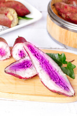 Purple Sweet Potatoes with Heart-Shaped Center on Wooden Board - Healthy Root Vegetables