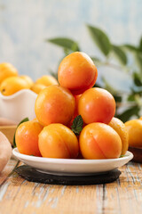 Fresh Xinjiang Apricots on White Plate - Organic Stone Fruit Display on Wooden Table