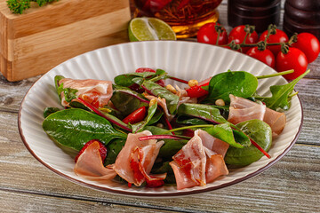 Salad with jamon, strawberry and arugula
