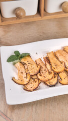 Fresh Wild Matsutake Mushrooms Sliced Golden Delicacies with Herbs on White Plate