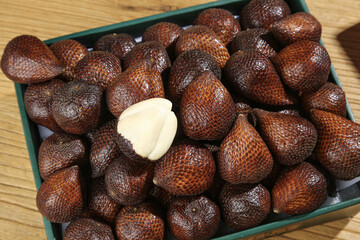 Fresh Snakeberry Fruits from Yunnan China in Container Showing Scaly Texture and White Flesh