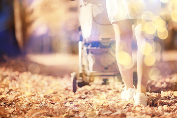 stroller view from the back legs, mom walk autumn abstract background fragment