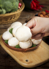 Fresh White Baby Mushrooms in Hand on Wooden Cutting Board Kitchen Food Photography