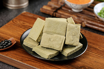 Traditional Yunnan Bean Curd Tofu Squares on Wooden Table - Chinese Vegetarian Protein Snack Food